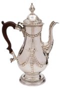 A George III silver coffee pot, maker James Young, London, 1772: crested, with domed hinged lid,