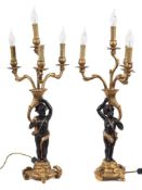 A pair of giltwood and ebonised figural candelabra: with four branches issuing form a cornucopia