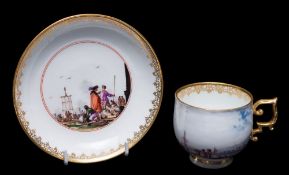A Meissen cup and saucer: the cup of ogee form with scrolling wishbone handle,