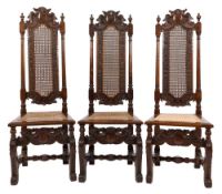A set of four 17th Century carved walnut dining chairs:,