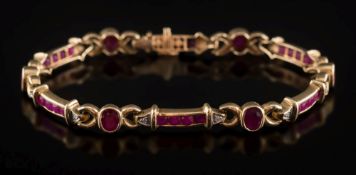 A ruby and diamond mounted bracelet: with circular ruby and diamond six-stone panels between oval