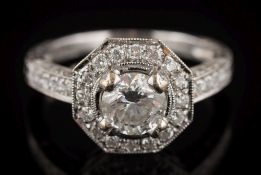 A modern 18ct white gold and diamond cluster ring: the central circular,