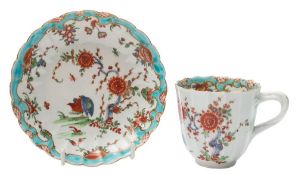 A First Period Worcester cup and saucer: of fluted form, the cup with entwined twig handle,