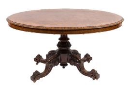 A Victorian carved walnut and inlaid oval breakfast or loo table:,