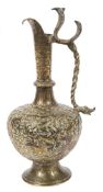 A 19th century Indian brass ewer: of baluster form with slender spout and shaped handle in the form