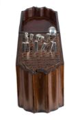 A George III mahogany and chequer strung knife box: of serpentine outline,