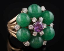 A diamond and gem-set dress ring: the central circular amethyst within a surround of feldspar