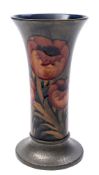 A Moorcroft Tudric pewter mounted vase: of trumpet shaped form tubelined in the Poppies pattern in