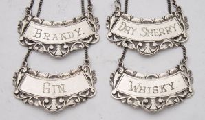 A set of four 20th century sterling decanter labels: 'Gin', 'Brandy', 'Whisky' and 'Dry Sherry',