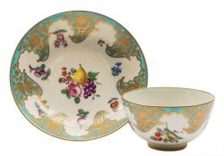 A First Period Worcester tea bowl and saucer: painted with a central spray of fruit and flowers