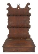 An 18th Century oak spoon rack:, of shaped fret cut outline,