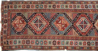 A Shirvan runner:, the field with a row of hexagonal medallions with cruciform and hooked designs,