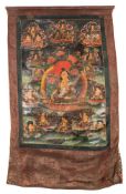 An Indo Tibetan thangka: the centre decorated with the seated figure of Buddha,