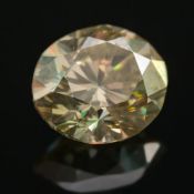 A fancy yellow unmounted diamond: the oval-cut diamond approximately 0.