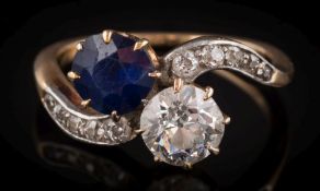 A sapphire and diamond two-stone crossover ring: the round, old brilliant-cut diamond 6.