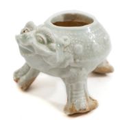 A Chinese Qingbai brush washer: in the form of a grotesque three legged beast,