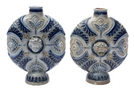 A pair of Martin Brothers salt glazed stoneware flasks or vases: of footed and flattened circular