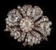 A 19th century silver and diamond encrusted flower head brooch: set with cushion shaped,