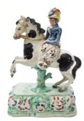 A Staffordshire pearlware equestrian figure: in the form of a lady wearing a feather plumed hat and
