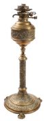 A Victorian brass telescopic oil lamp: the bulbous reservoir with banded foliate decoration on a