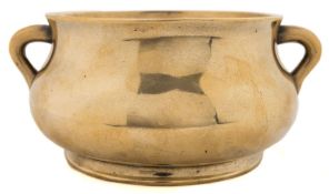A Chinese bronze censer: of squat circular form with loop carrying handles to the sides,