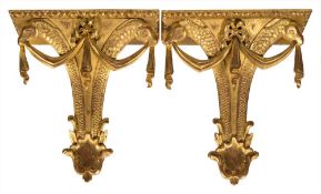 A pair of carved giltwood wall brackets,