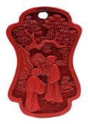 A Chinese cinnabar lacquer pendant: of waisted cartouche form, each side carved with figures,