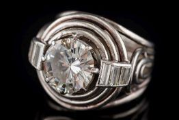 An art deco-style diamond solitaire ring: the circular old, brilliant-cut diamond approximately 9.
