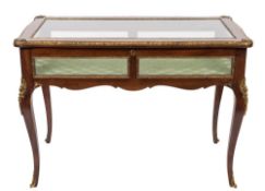 A mahogany and gilt metal mounted rectangular bijouterie display table of serpentine outline in the