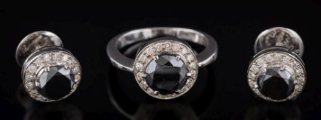 A diamond and black diamond circular cluster ring: with a circular black diamond approximately 2.