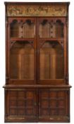 A late Victorian oak and decorated bookcase in the manner of A. W. N.