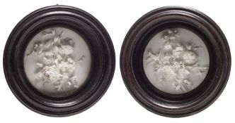 A pair of Bristol biscuit porcelain flower plaques: each circular plaque finely applied in high