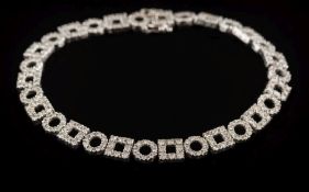 A diamond mounted line bracelet: the circular and square links with round,