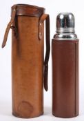 A brown leather mounted Thermos flask in leather hunting case:.