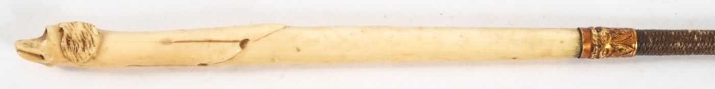 A Victorian carved ivory handled riding whip with dog's head terminal:, 75cm long.