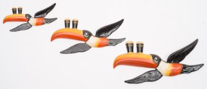 A set of three Carlton Ware Guinness flying Toucan wall plaques:, painted in colours,