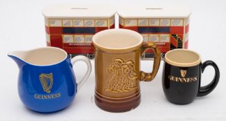 A small group of Guinness wares:, comprising two Carlton Ware Trolley Bus money banks,