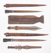 A group of four African short swords:, three in leather scabbards,