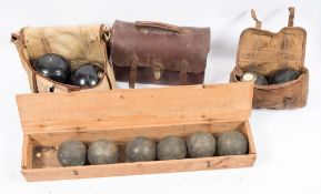 Three sets of Lawn Green bowling woods and a set of boules:.