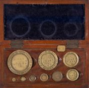 A cased set of early 20th century brass Exeter City Council weights:, 8oz to 1/2DR,