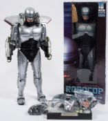 A loose Enterbay 1/4th scale Robocop figure with a small group of accessories:,