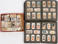 Two early 20th century cigarette card albums: and contents and a small collection of loose cards,
