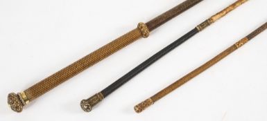Three Victorian gilt metal mounted riding whips:.