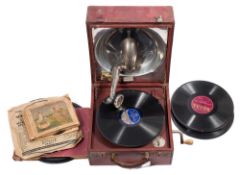 A red leather cased Decca portable wind-up gramophone: and quantity of 78rpm records.