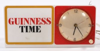An illuminated 'Guinness Time' clock:, 14.5 x 30cm.