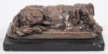 T Hingre, a 19th century patinated bronze of a recumbent dog:, on a cushion base,