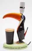A Carlton Ware Guinness Toucan lamp:, painted in colours with advertising slogan to base,