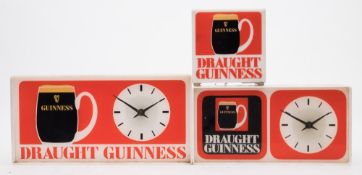 Two white Perspex 'Draught Guinness' clocks and a cube bar lamp:,