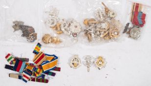 A group of military cap badges and medal ribbons:, including a Prince Albert's,