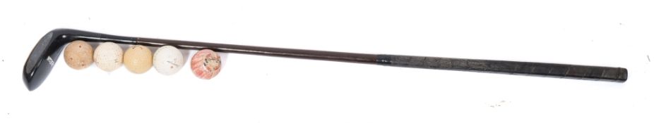 A 'Black Magic' putter by Forgen ,St Andrews:, together with five various golf balls.